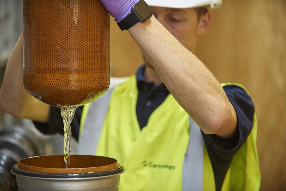 Engineer changing a commercial water filter