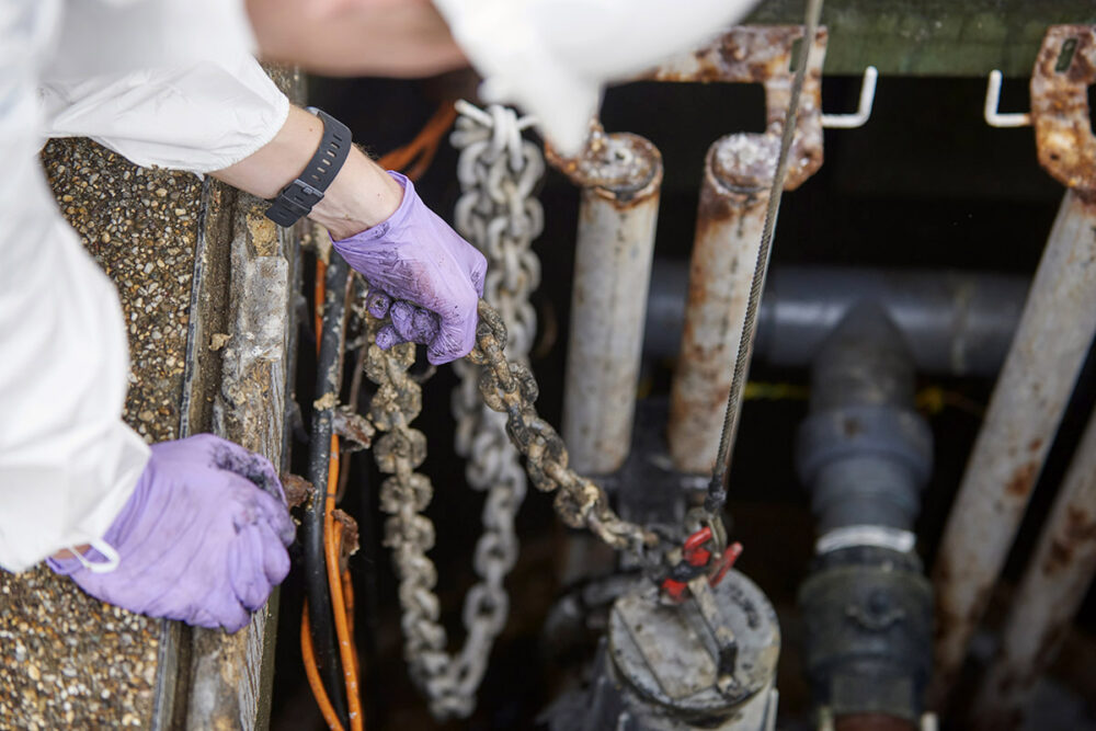 Engineers raising a sewage pump