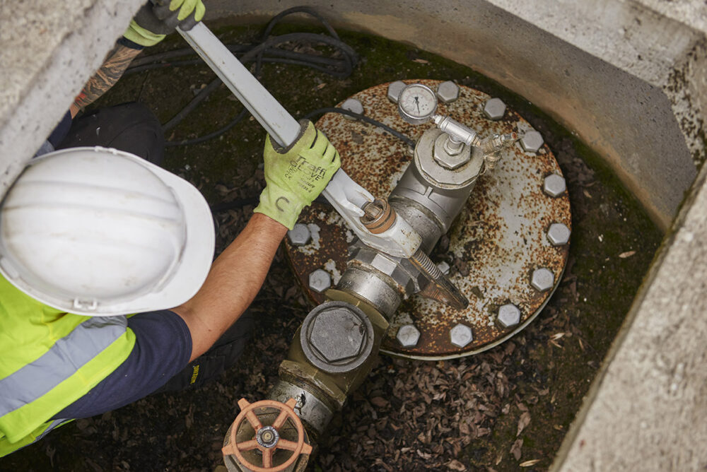 Using a wrench on the head of a borehole